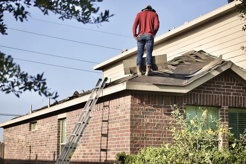 Professional roofer working on a residential roof in Wyman Park